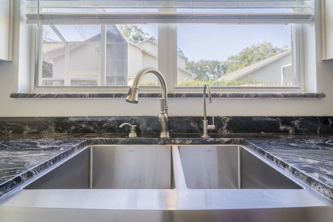 Building Photo - Beautiful 4/2 home Located on a tree lined street in the gate of country club community of the Hu...