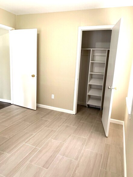 Tile floor in the oversized fourth bedroom/flex room/family room with large walk in closet - 4244 Asbury Ave