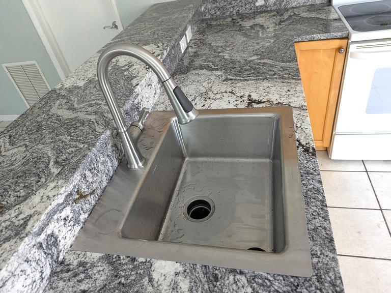 Large SS sink pull down faucet and disposer - 1225 SW 4th Ct