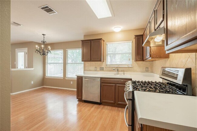 Building Photo - No Carpet! Tons of Space! Beautiful backyard with large covered patio!