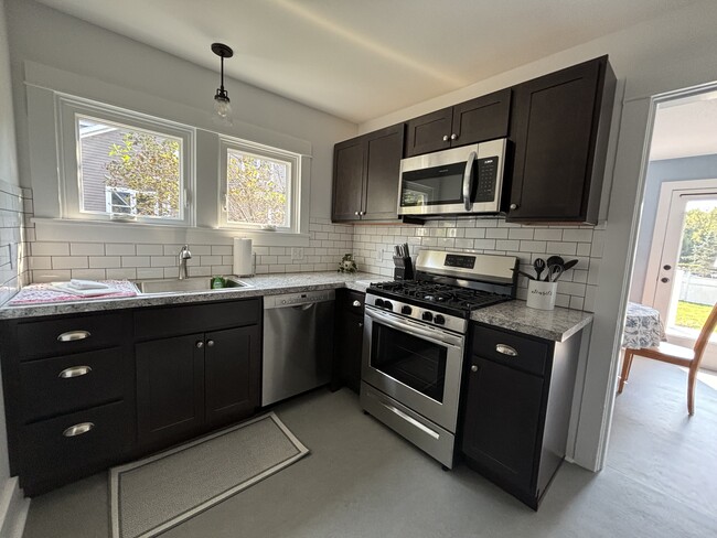 Newly remodeled kitchen has gas stove and new appliances - 1305 Hanshaw Rd