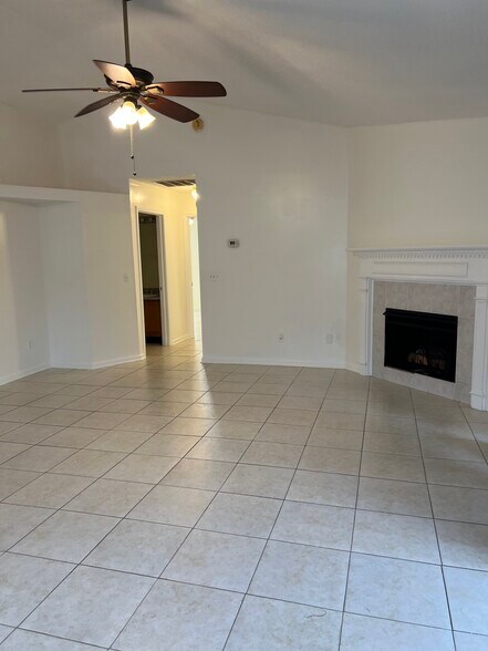Open-layout living room with a cozy fireplace — perfect for relaxing or entertaining guest - 5374 Lacy Jane Way