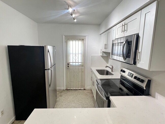 Building Photo - SPACIOUS UPGRADED TWO-BED ONE-BATH UNIT LOCATED IN THE HEART OF LITTLE HAVANA. THE BUILDING HAS A...