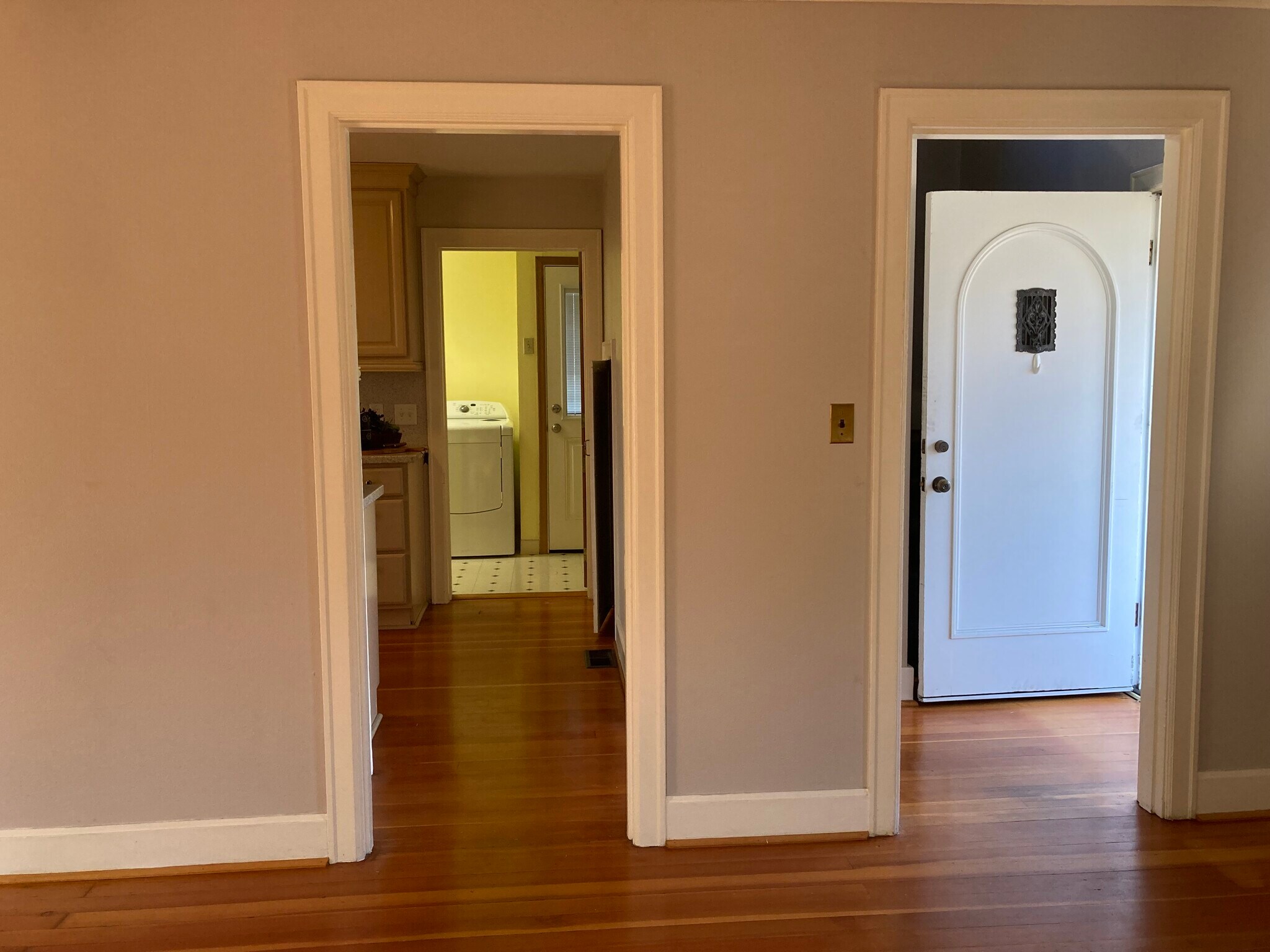 View from living room showing kitchen, laundry/half bath/side door, & stairs are behind the door - 915 John Adams St