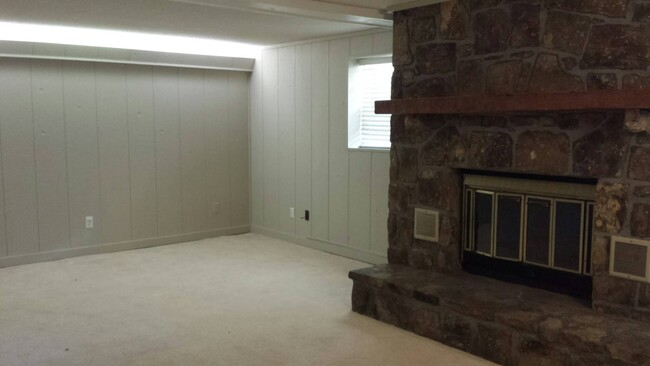 lower level living area with wood burning fireplace, connects to 3 car covered parking via mudroom - 826 Murrell Rd