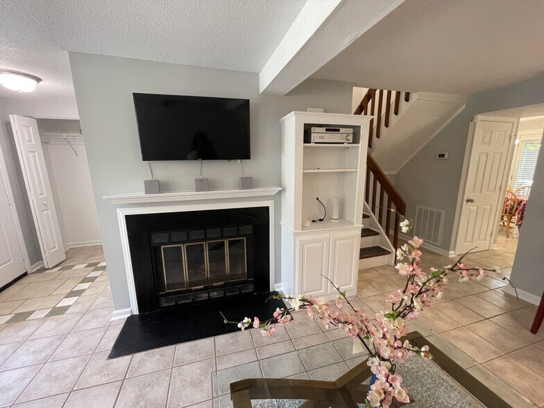 Living Room with built-in entertainment center, telescoping TV mount, and wired surround sound - 4204 Whistler Ct