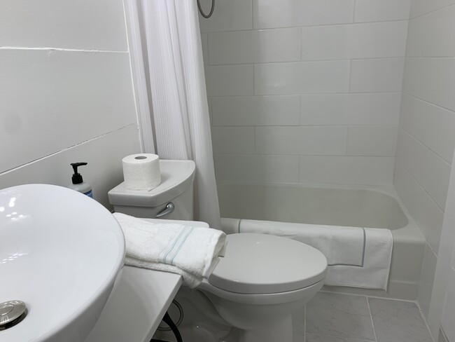 Shiplap and porcelain tile bathroom. - 322 E 19th St