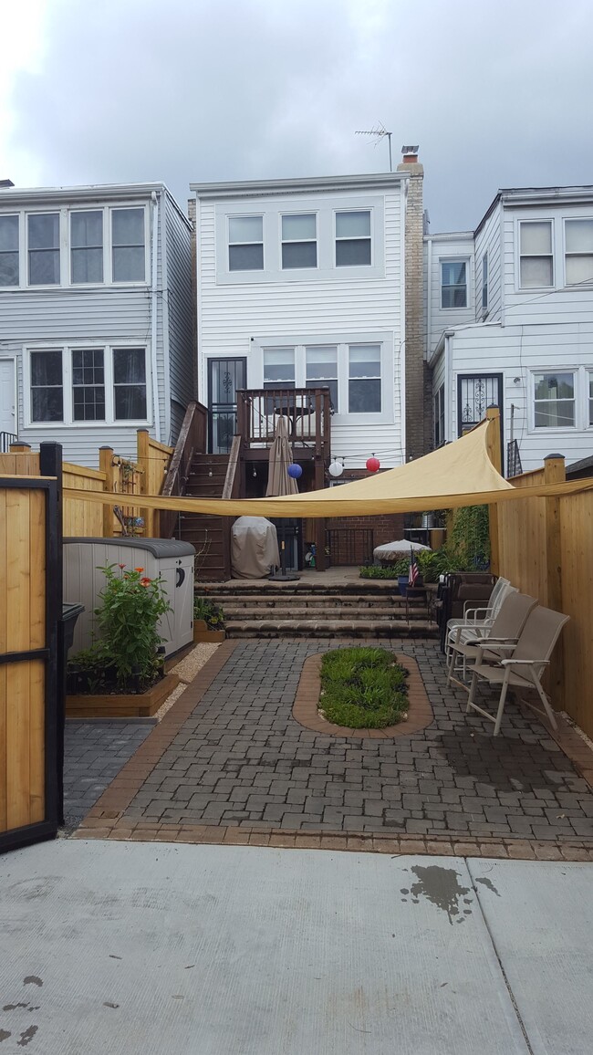 Parking pad, deck, back patio, secured by a new, lockable gate and fence. - 526 24th St NE