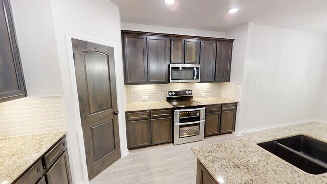 Building Photo - Welcome home to this beautifully designed 4-bedroom, 2.5-bathroom gem!