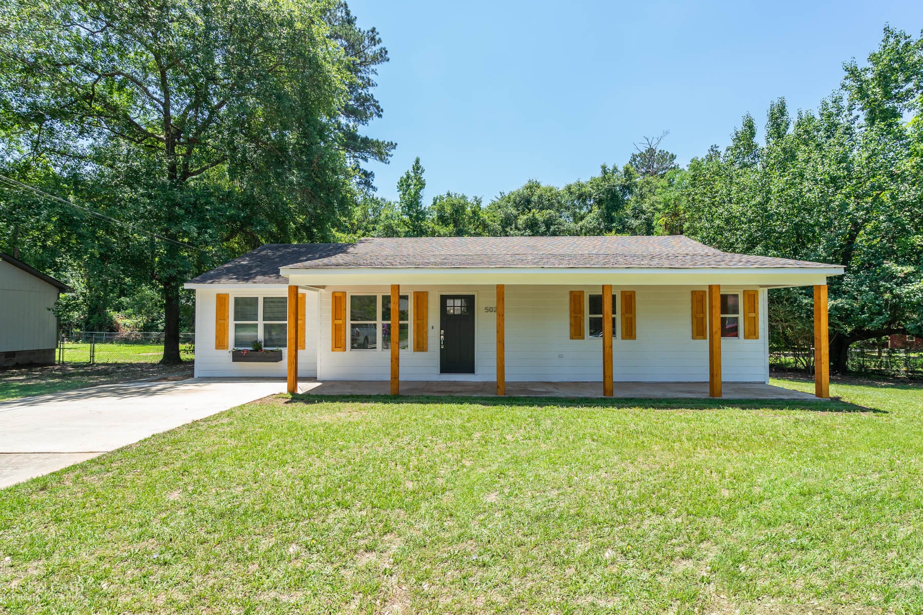 Street view of home - new front door, shutters, columns, windows and siding - 502 Cherokee Court