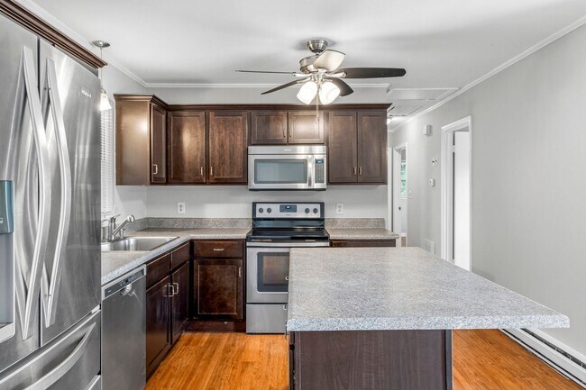 Building Photo - Updated Home, Stainless Steel Appliances, Wood Like Flooring, Deck, Garage!