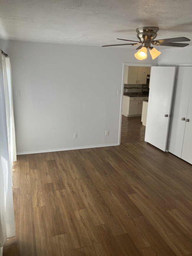 Master bedroom with new laminate flooring private access to backyard and new fan - 13559 Red Fern Ln