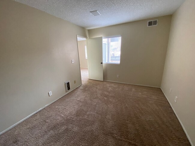 Building Photo - 2 BR 2 BA Corner Condo w/Balcony W/D Gated Entry Carport + Space