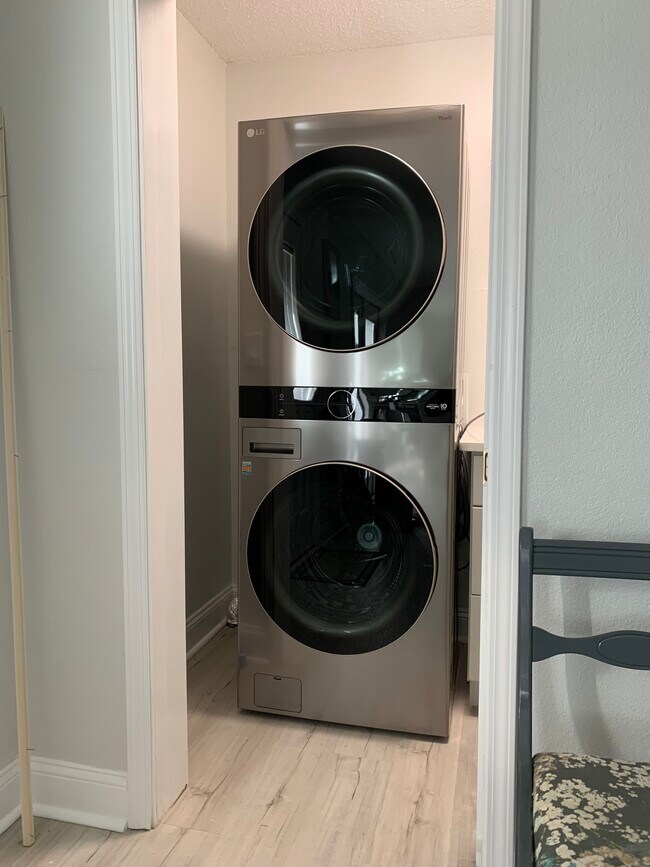 Washroom with stackable washer and dryer. - 1301 E Leonard St