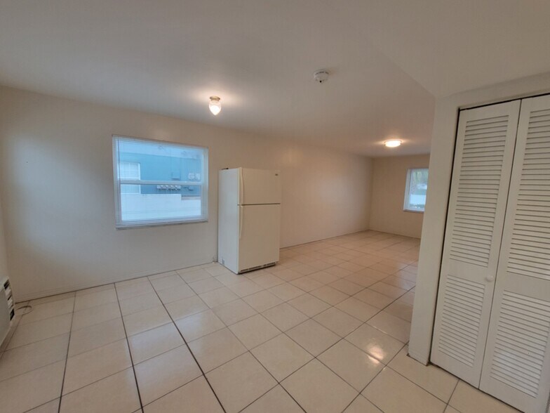 Living/dining with windows open. Shows refrigerator in living area as an option. - 6100 Dr Martin Luther King Jr St N