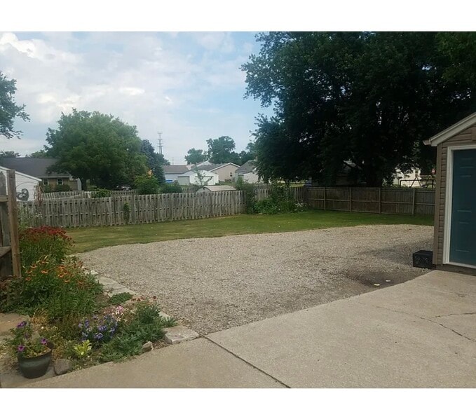backyard is fenced in on three sides and there is a fenced garden - 626 George St