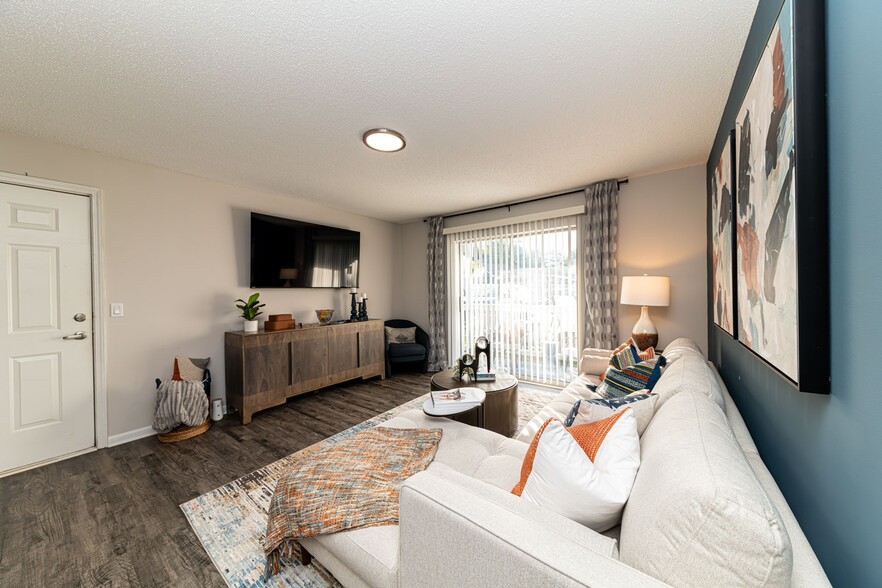 Spacious living room with hardwood-style flooring - The Linden Apartment Homes