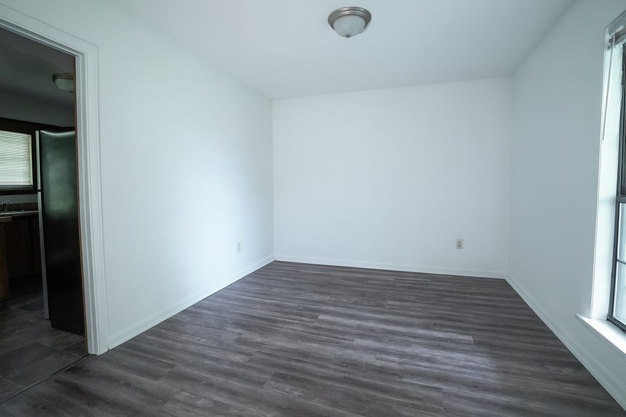 Spacious dining area with natural light and updated laminate flooring. - 2313 Salem West Dr