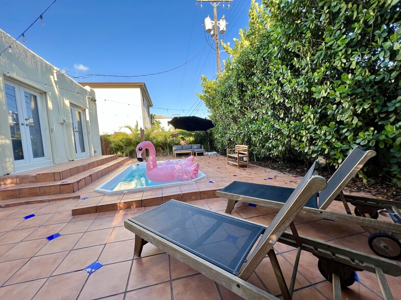 Backyard Oasis with Lounge Chairs & Seating Area with Large Umbrella - 1328 SW 21st Ter