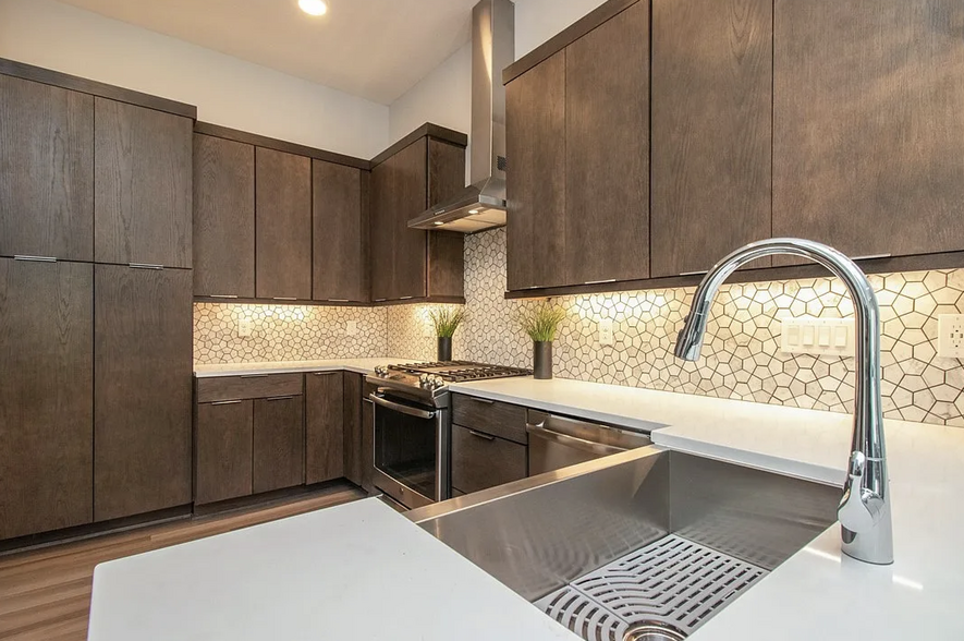 The kitchen with high quality, modern appliances and quartz counter top. - 216 E Center St