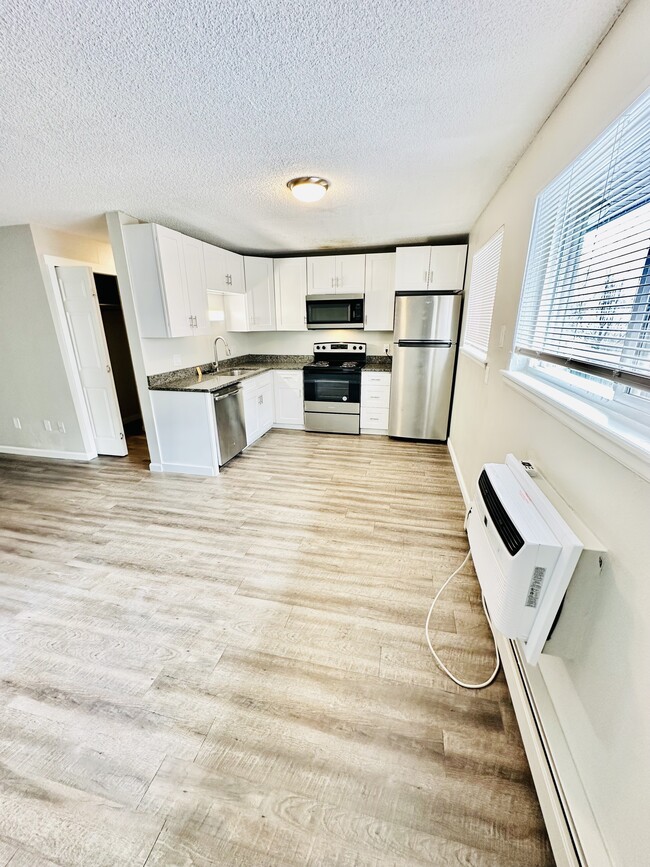 Experience the elegance of this modern kitchen, perfect for culinary creations. - Hawk Point Apartments