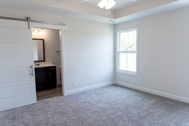 Building Photo - Modern Living Redefined with Stone Fireplace, Gray Cabinetry, Spa Inspired Primary Suite and Cove...