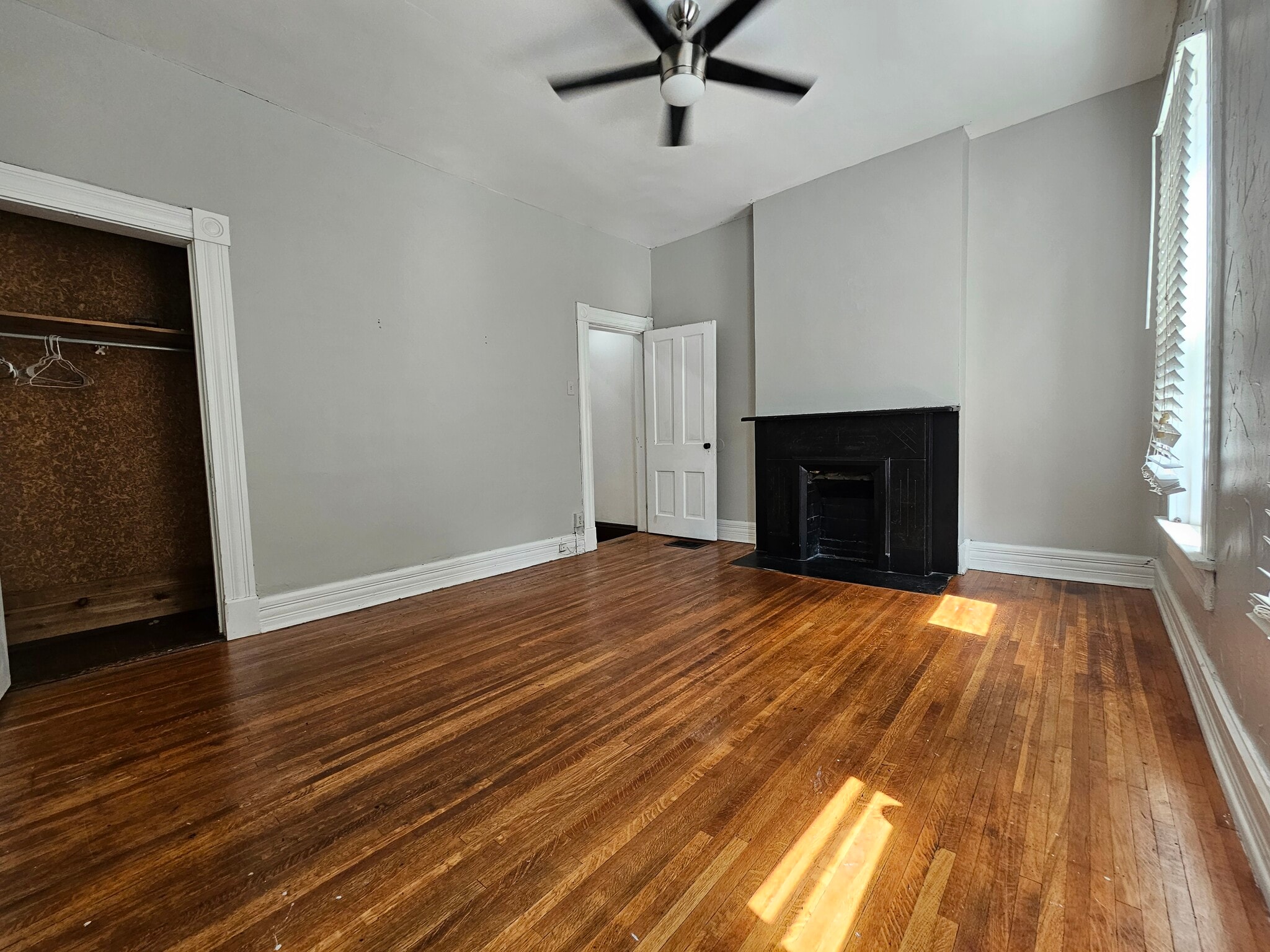 Wooden floors and modern ceiling fan/ light fixture. High ceilings. - 943 Highland St
