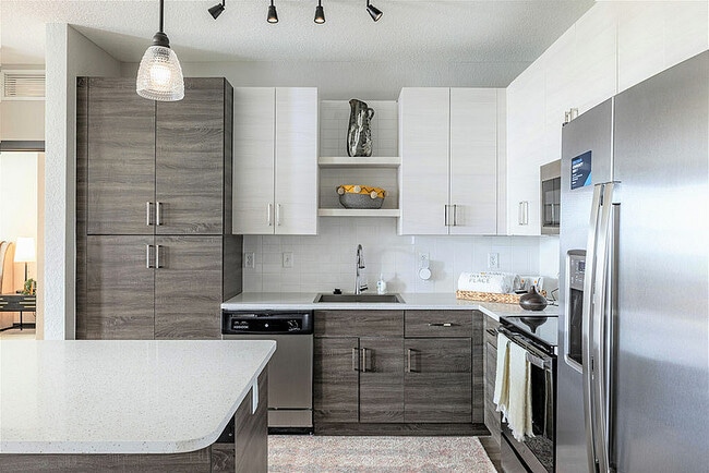 Experience culinary luxury in this contemporary kitchen, featuring high-end finishes and ample storage. - Irving Place North Rocky Point