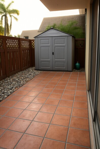 Tile patio with brand new gate and gravel. - 8601 SW 94th St
