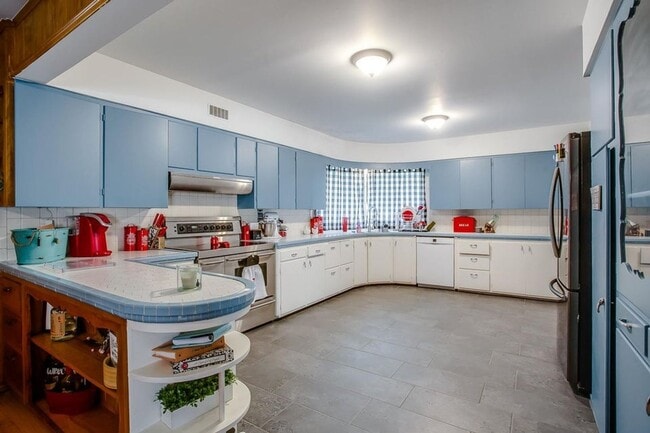 Building Photo - Spacious 4-Bedroom Home with Dual Living Areas