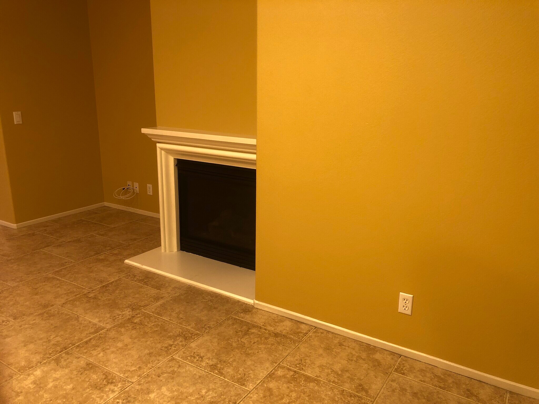 Living room with fireplace , flooring large tiles . - 6395 Delgado Ln