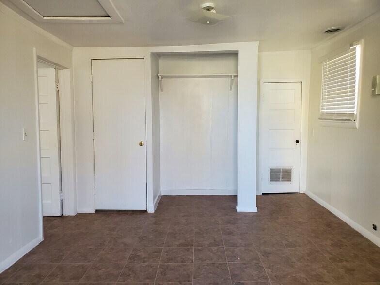 bedroom, looking toward bathroom door (left), bedroom closet (center) and utility closet (right) - 635 Elm Ave