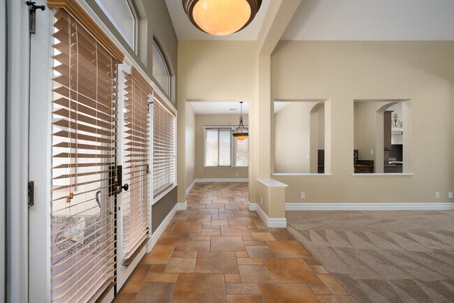 Living room and family room separated by cozy 2-way fireplace with a wet bar - 2850 Bronzino Ct