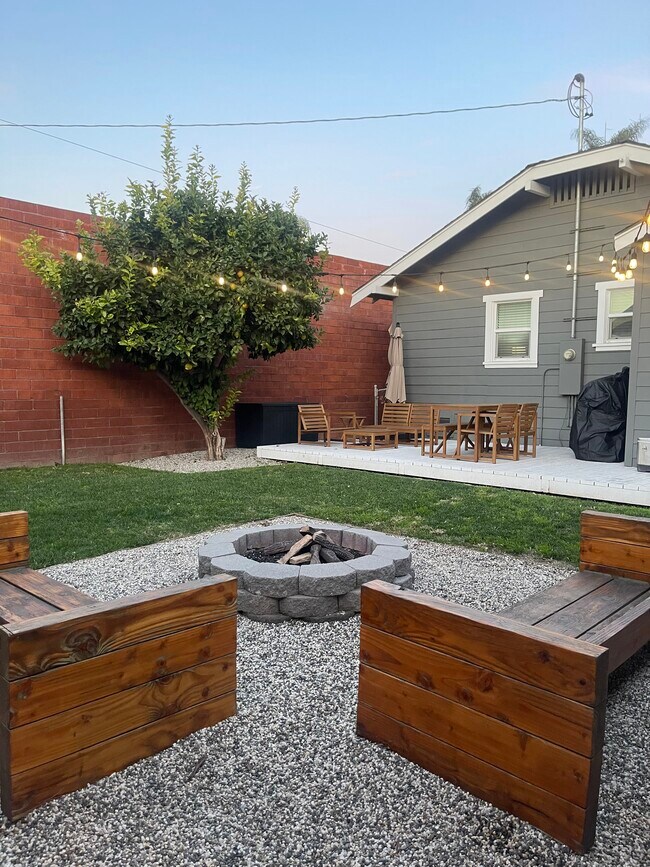 Outdoor gas fire pit, lounging areas, cushions for seating, BBQ and umbrellas and lemon tree shade - 1075 Redondo Ave