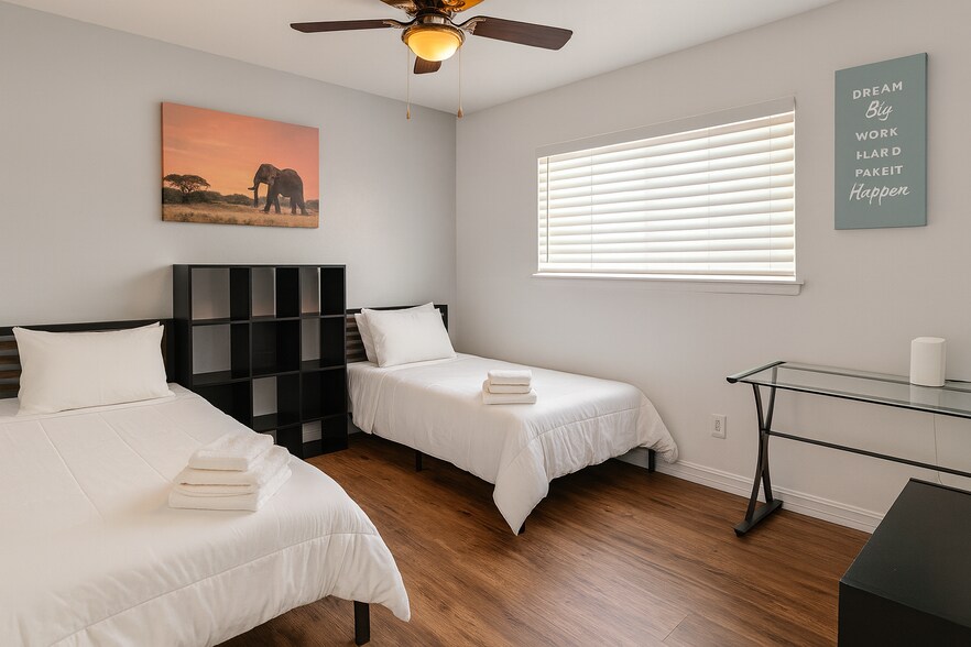 Guest bedroom with 2 twin beds and work desk—great for childrens or travelers. - 10116 Mercedes St