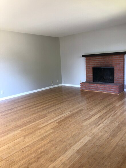 Living room with bamboo floors and beautiful fireplace - 870 Coolidge Ave