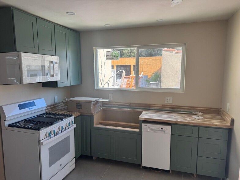 new kitchen with butcher block and a farmhouse sink. - 10821 Otsego St