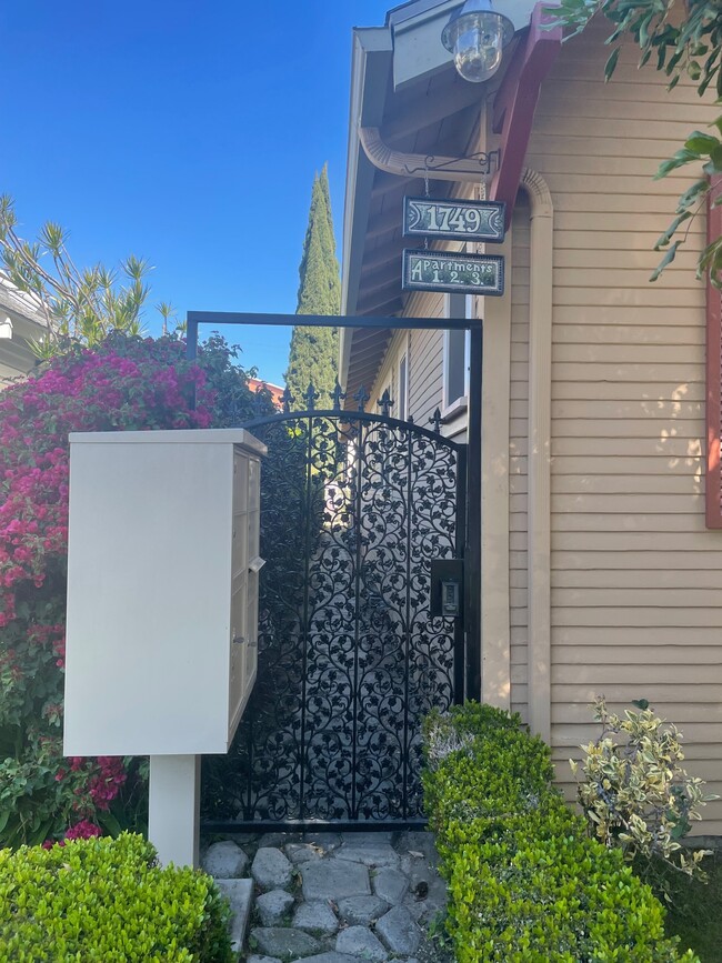 Triplex mailboxes and entry gate. - 1749 E 3rd St