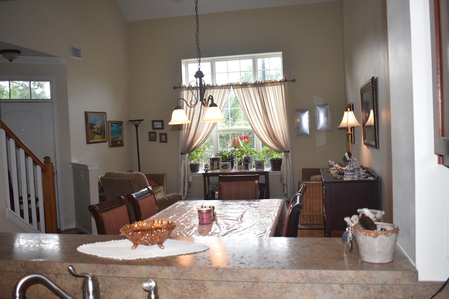 View from kitchen through the eating area and living room - 1007 RIVERS ARCH