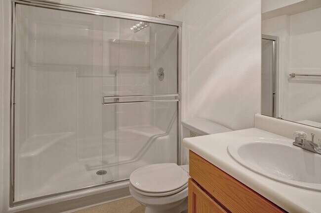 A bathroom with cabinet storage and a large standing shower - Lake Park