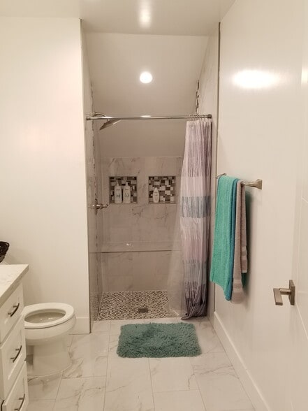 Step in shower with bench. - 4449 S Slauson Ave
