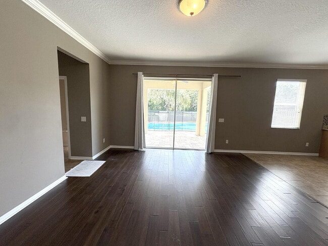 Building Photo - Spacious 5-Bedroom Pool Home with Putting ...