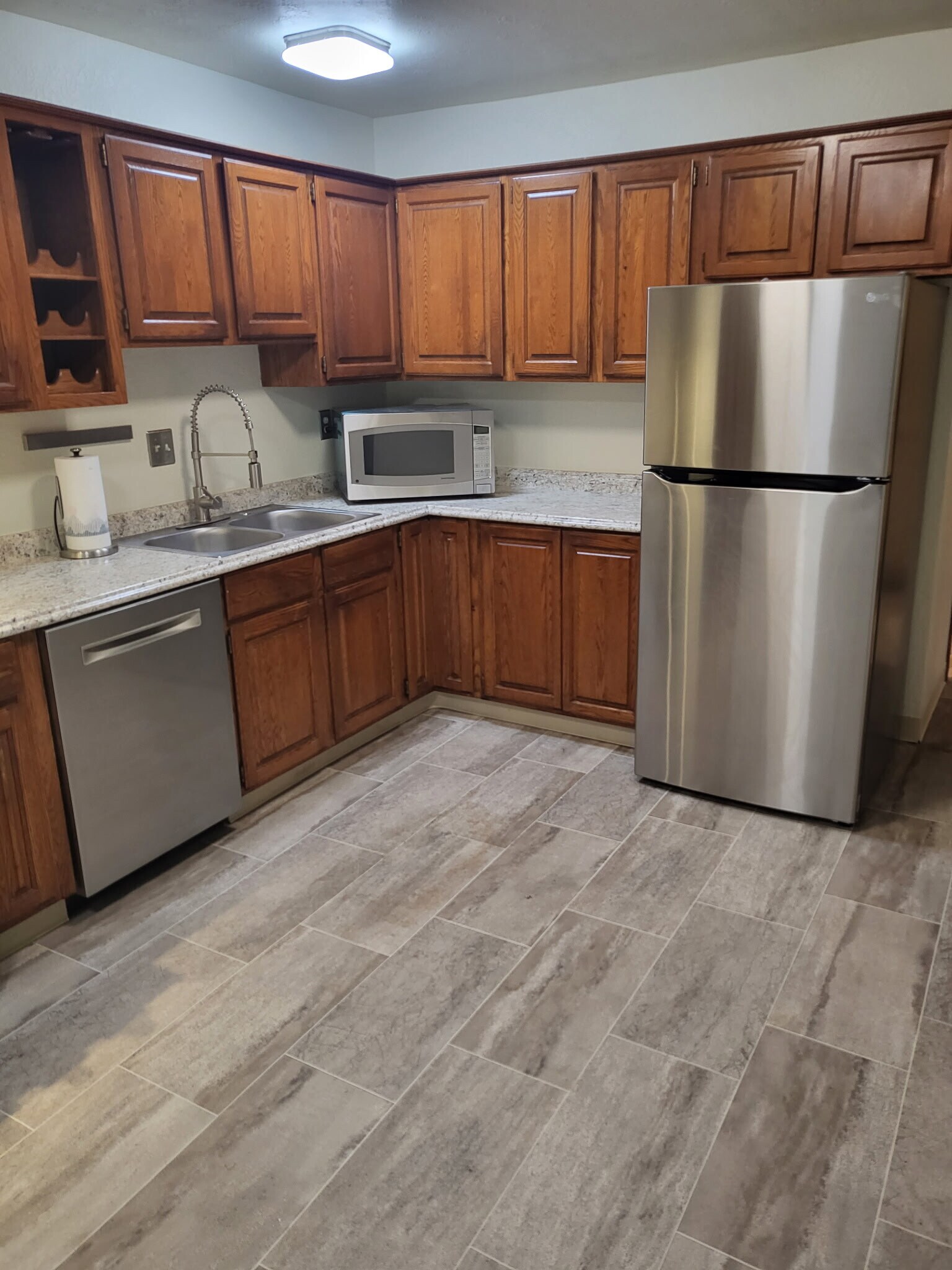 Roomy kitchen has upgraded stainless appliances & counters; plenty of cabinet space! - 20005 1st Ave S