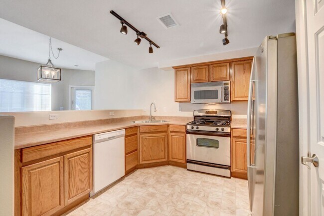 Building Photo - FIRST FLOOR CONDO IN GATED COMMUNITY W/ SINGLE CAR GARAGE