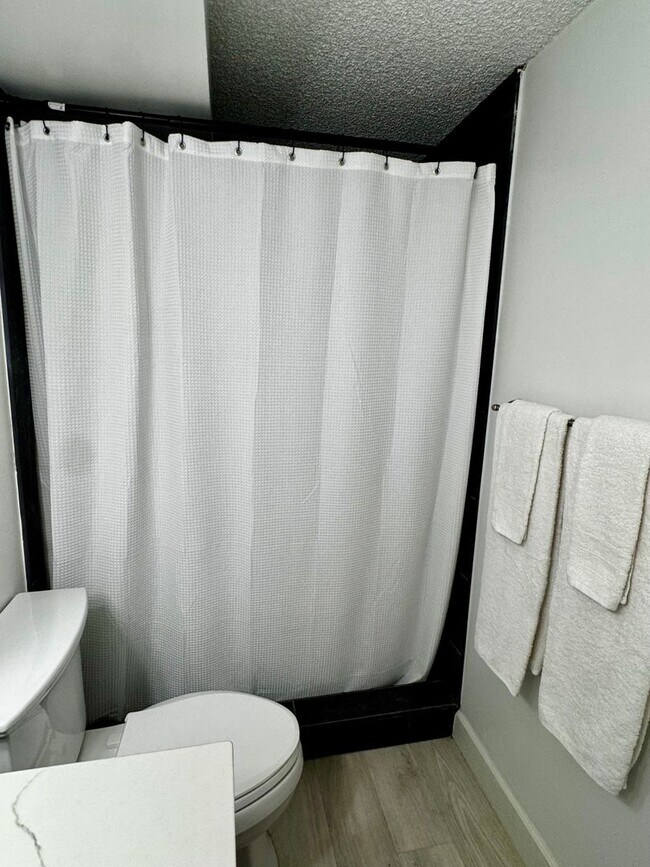 Building Photo - Upgraded Fully Furnished Condo w/ Assigned...