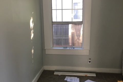 Bedroom with neautral carpet and bathroom - 605 W 8th St