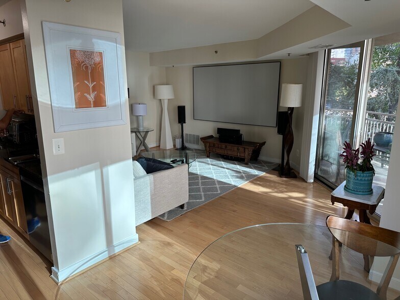 living room with view of balcony - 7500 Woodmont Ave
