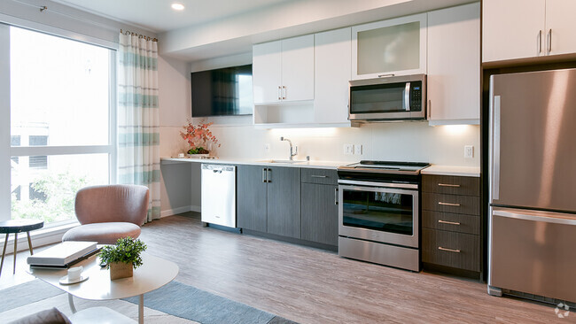 Stunning Galley-style kitchens with stainless steel appliances and wood plank flooring - Modera San Pedro Square