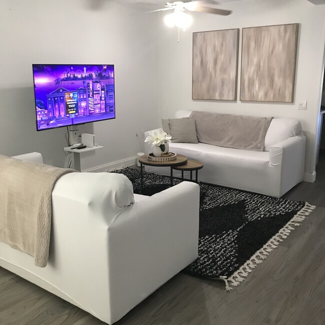 Living room, see the new floors and new hurricane impact window examples throughout the whole house. - 767 SW Ravenswood Ln