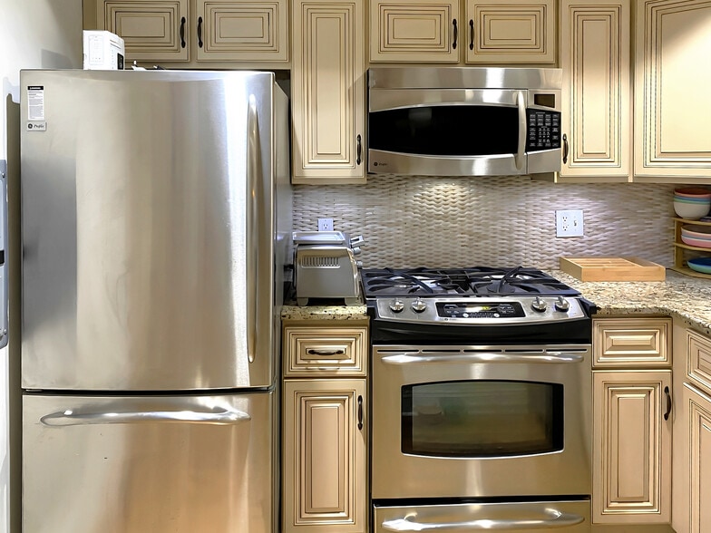 Kitchen area, stainless steel appliances, granite countertop, toaster oven. - 328 Garden St